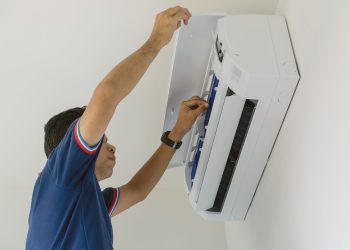 air-conditioner-repairers-blue-uniform-are-checking-repair-air-hanging-wall